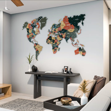 Sage metal world map hung in a living room above a dark console with a sofa in the foreground