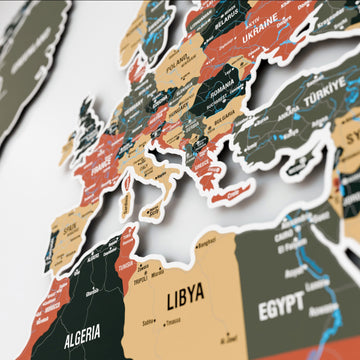 Angled close-up of Europe and North Africa on the sage metal world map with Poland, Romania and Libya