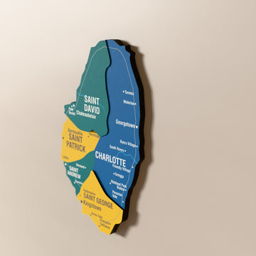 Close-up of the Flag colored Saint Vincent and the Grenadines wooden wall map with layered regions and printed names