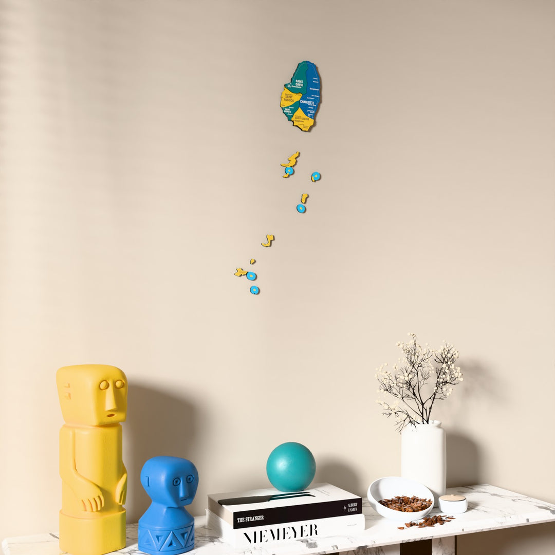 Flag colored Saint Vincent and the Grenadines wooden wall map on a beige wall above a console with figurines