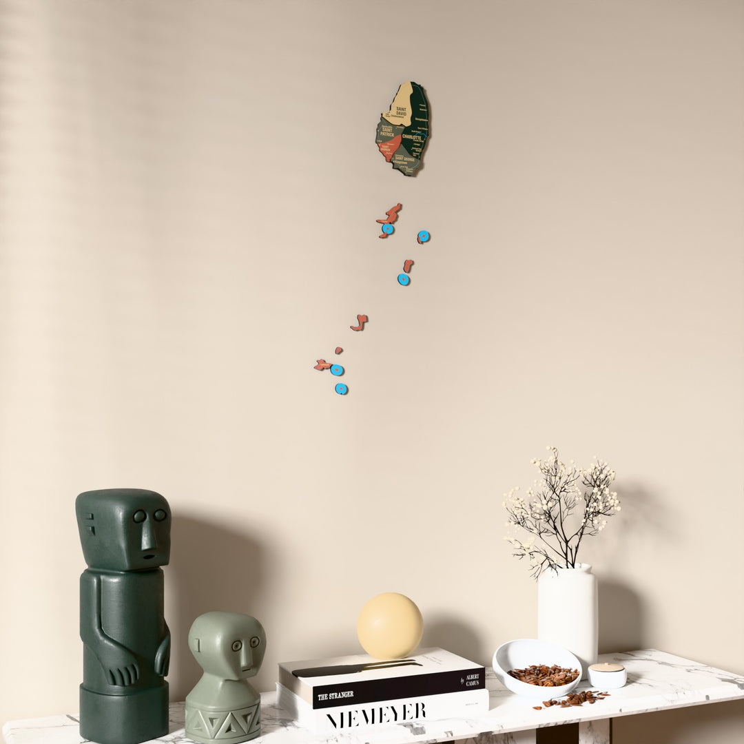 Sage Saint Vincent and the Grenadines wooden wall map on a beige wall above a console with figurines