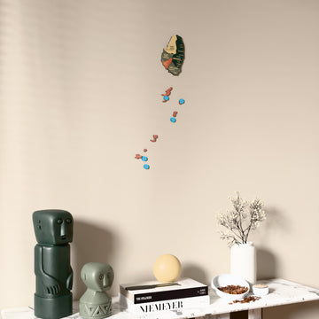 Sage Saint Vincent and the Grenadines wooden wall map on a beige wall above a console with figurines