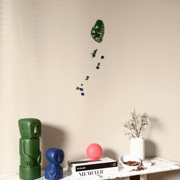 Satellite Saint Vincent and the Grenadines wooden wall map on a beige wall above a console with figurines