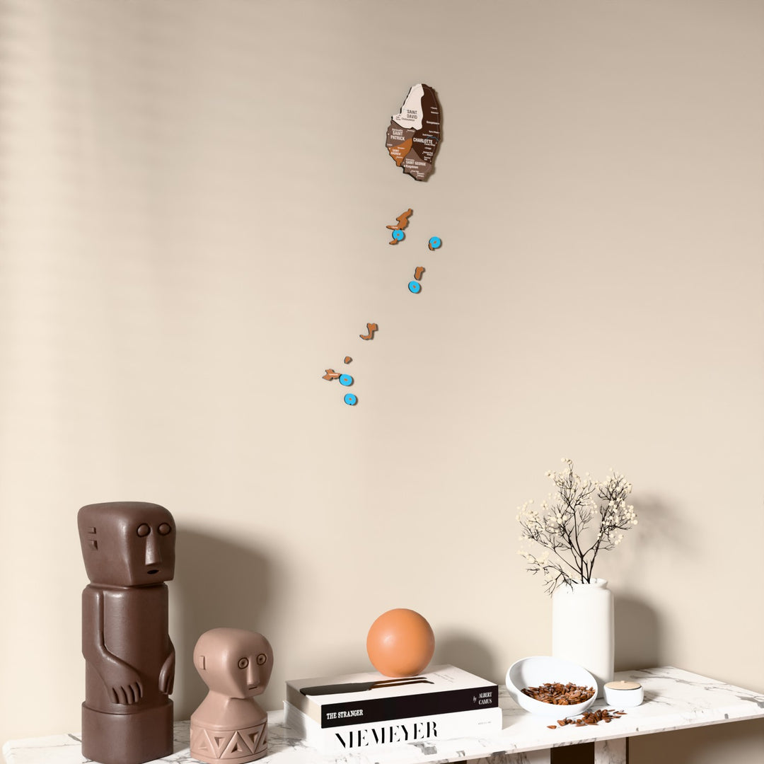 Soil Saint Vincent and the Grenadines wooden wall map on a beige wall above a console with figurines