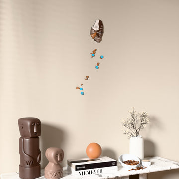 Soil Saint Vincent and the Grenadines wooden wall map on a beige wall above a console with figurines