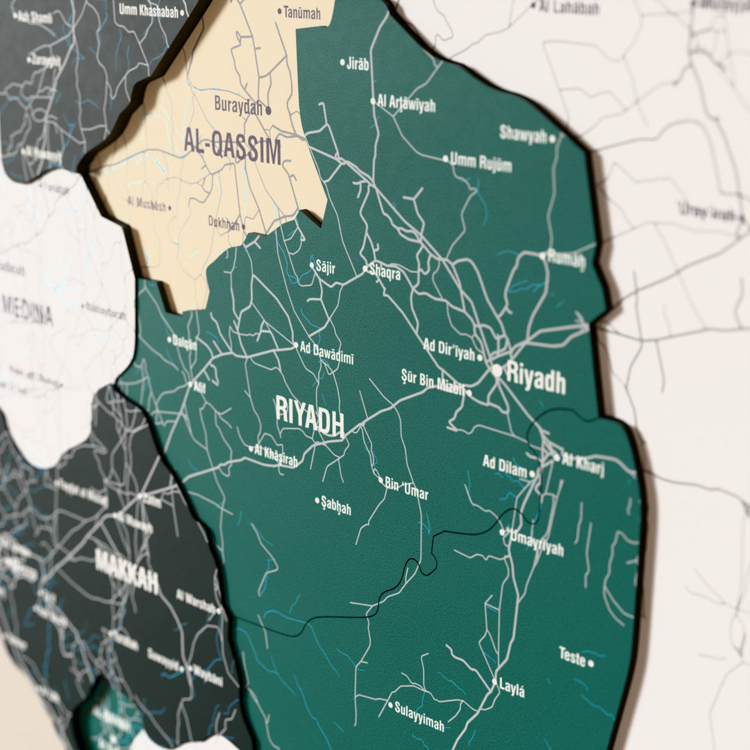 Close-up of the Flag colored Saudi Arabia wooden wall map with layered regions and printed names