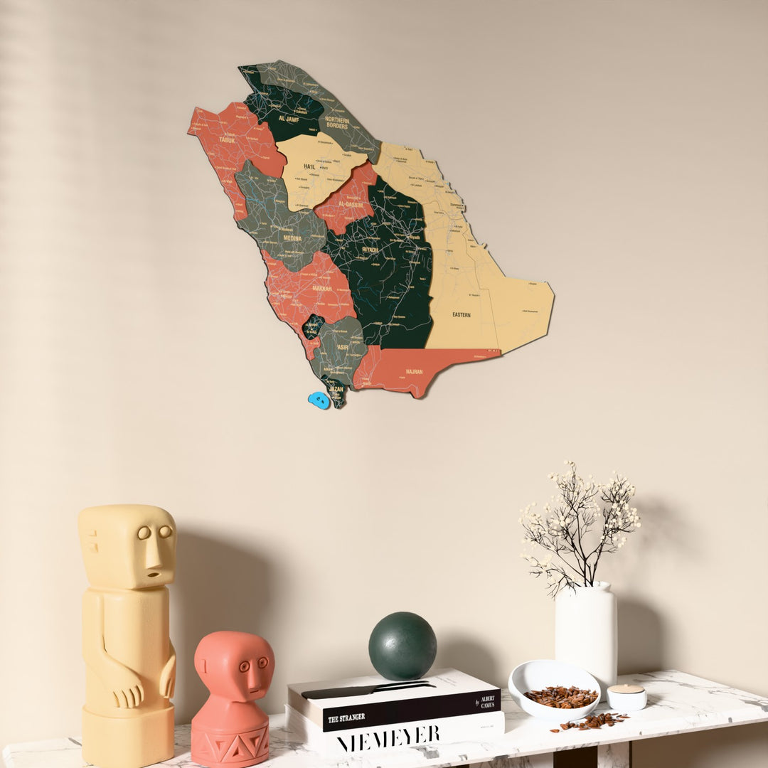 Sage Saudi Arabia wooden wall map on a beige wall above a console with figurines
