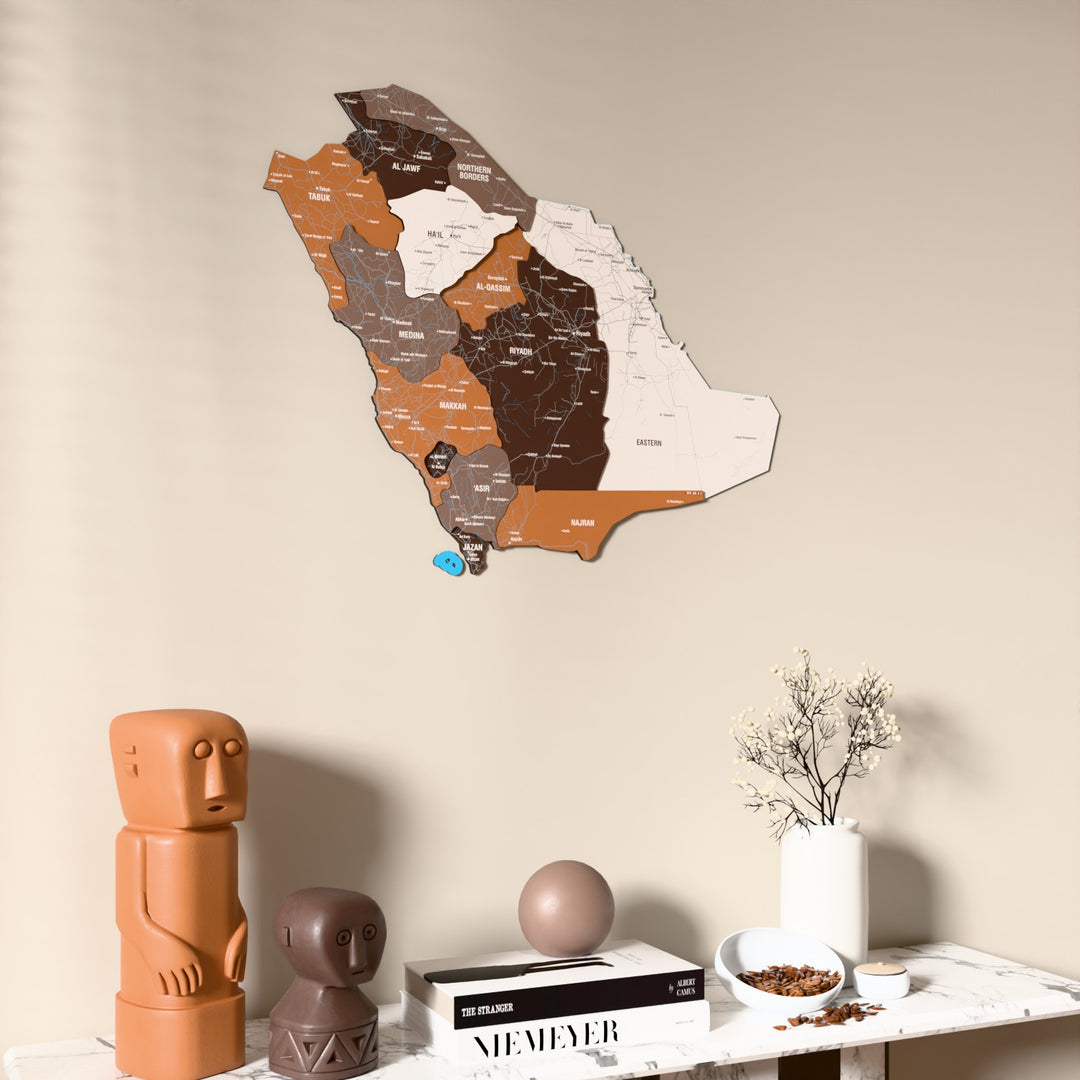 Soil Saudi Arabia wooden wall map on a beige wall above a console with figurines