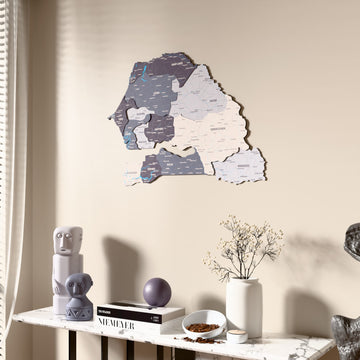 Nimbus Senegal wooden wall map beside a sheer curtain, angled view
