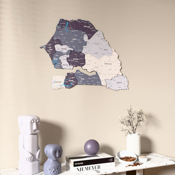 Nimbus Senegal wooden wall map on a beige wall above a console with figurines