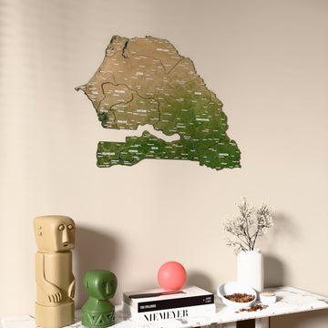 Satellite Senegal wooden wall map on a beige wall above a console with figurines