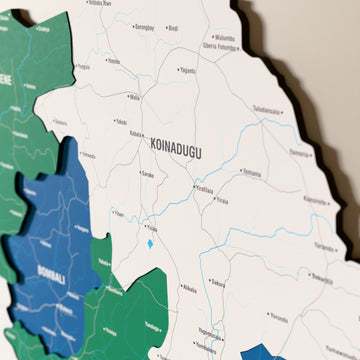 Close-up of the Flag colored Sierra Leone wooden wall map with layered regions and printed names