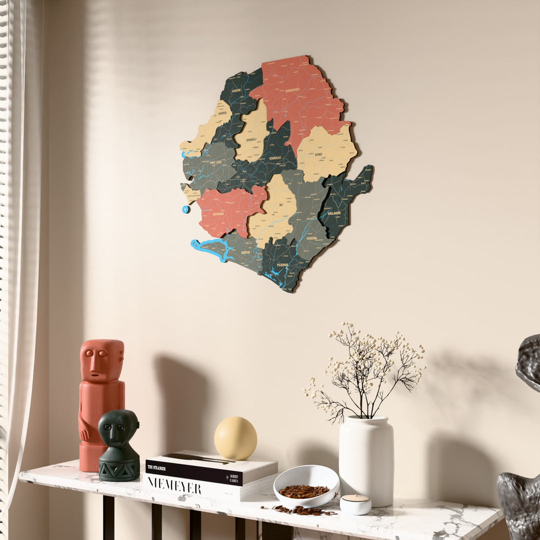 Sage Sierra Leone wooden wall map beside a sheer curtain, angled view