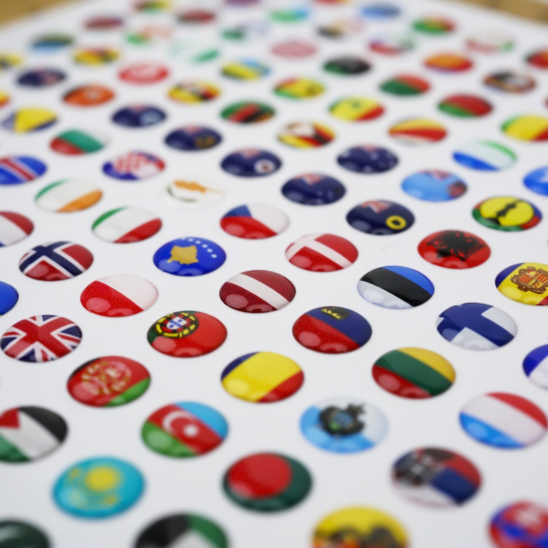 Flag pins in the 276 silicone pin set, glossy domed surface, angled close-up