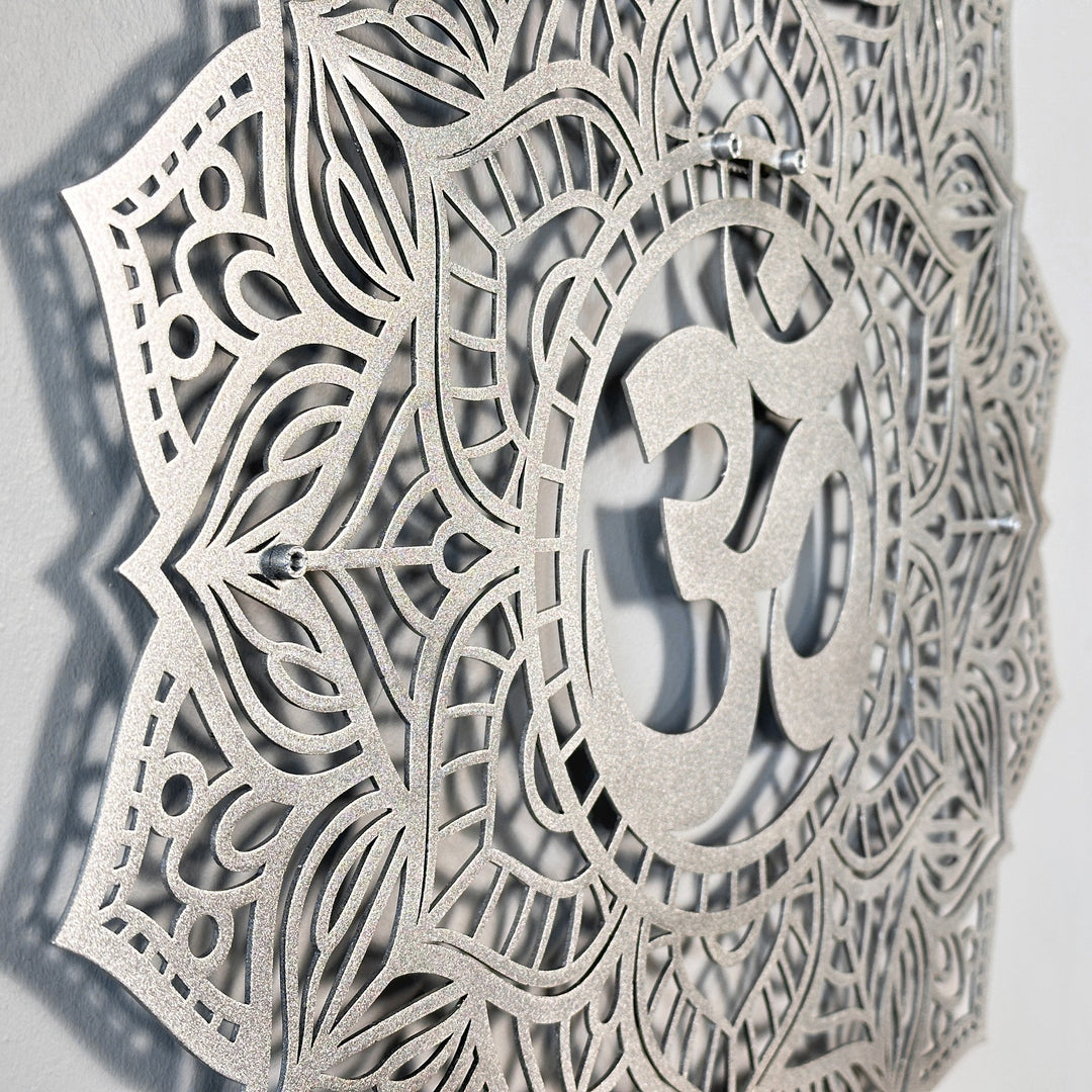 Side-angle close-up of the silver OM mandala metal wall art showing the raised OM symbol and mounting points