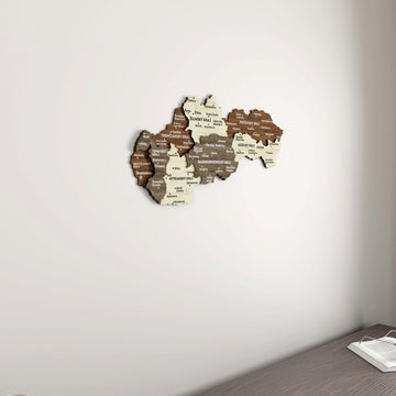 Slovakia wooden wall map in a corner angle, with the edge of a desk and an open book at the bottom