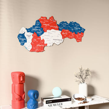 Flag colored Slovakia wooden wall map on a beige wall above a console with figurines