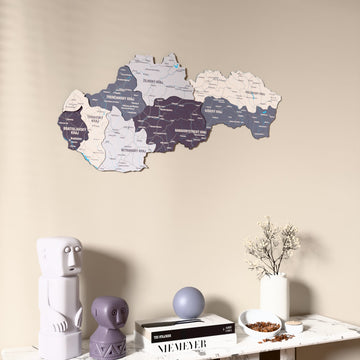 Nimbus Slovakia wooden wall map on a beige wall above a console with figurines