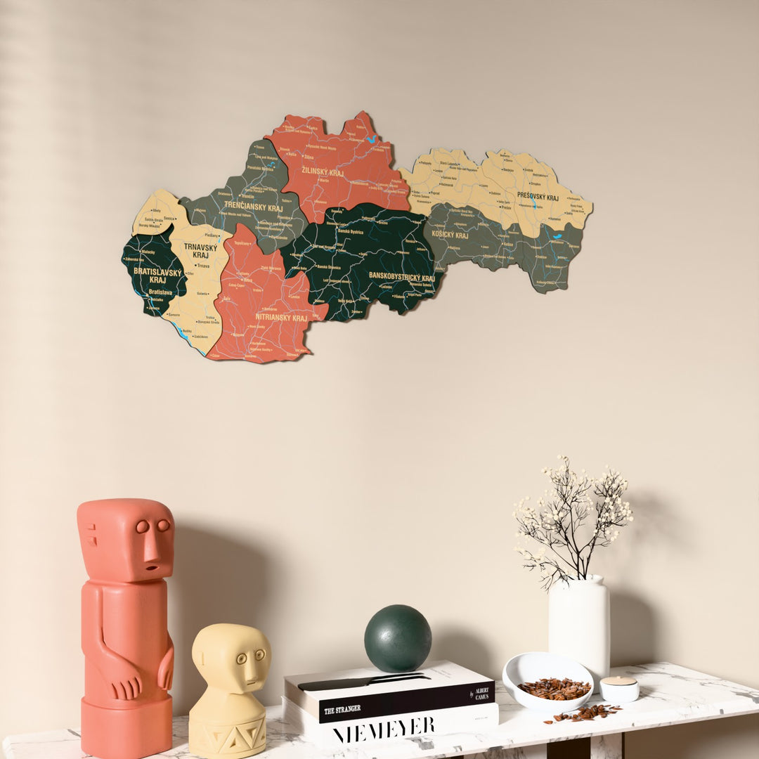 Sage Slovakia wooden wall map on a beige wall above a console with figurines