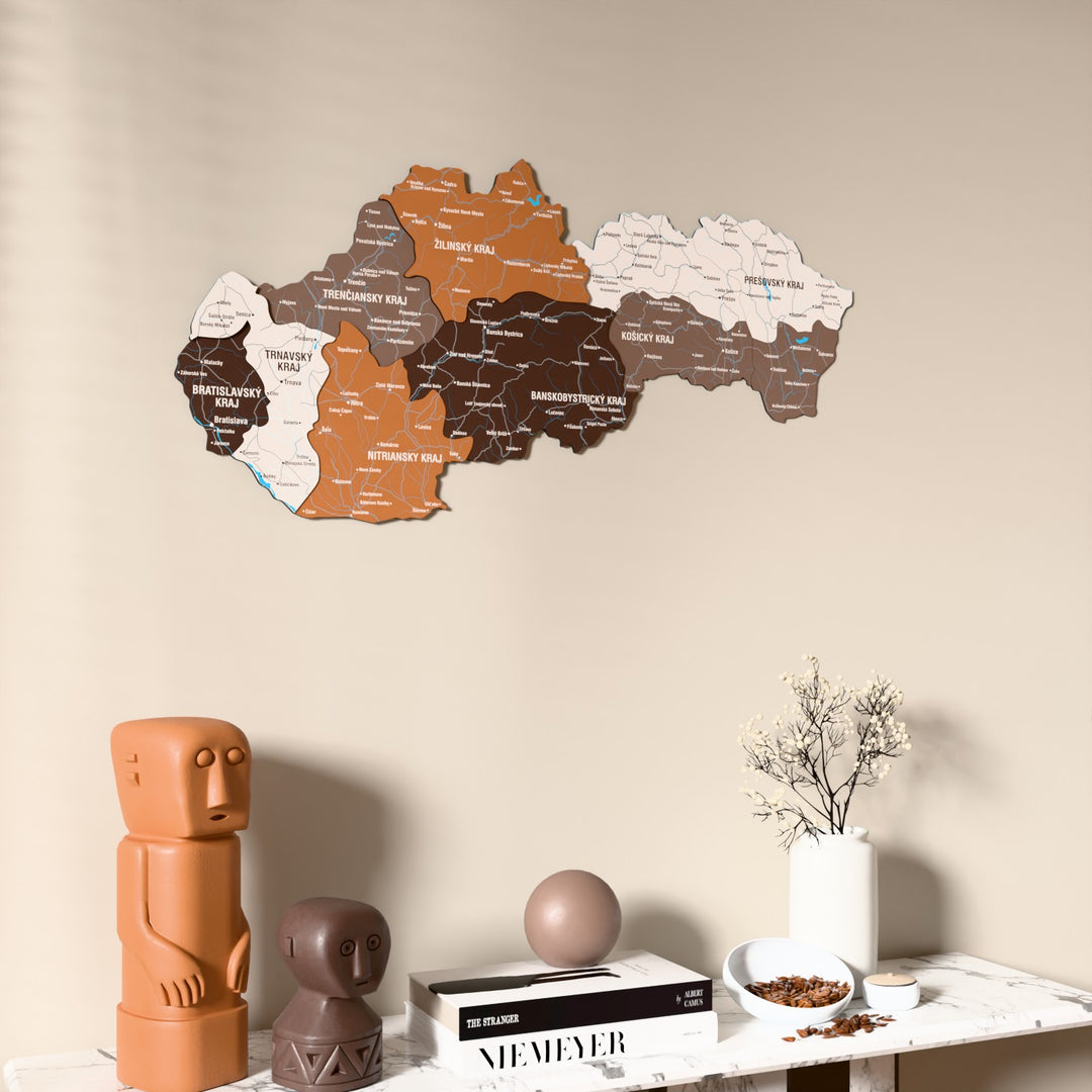 Soil Slovakia wooden wall map on a beige wall above a console with figurines