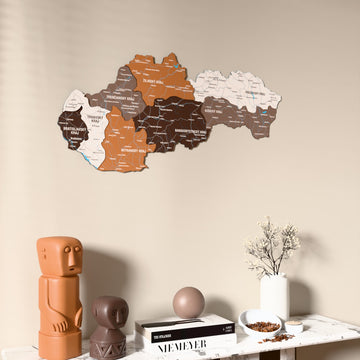 Soil Slovakia wooden wall map on a beige wall above a console with figurines
