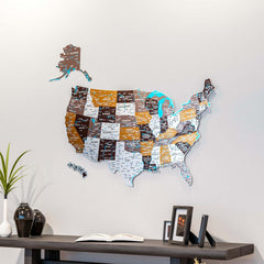 Soil UV-printed metal map of the United States in brown, orange and white above a dark shelf with vases