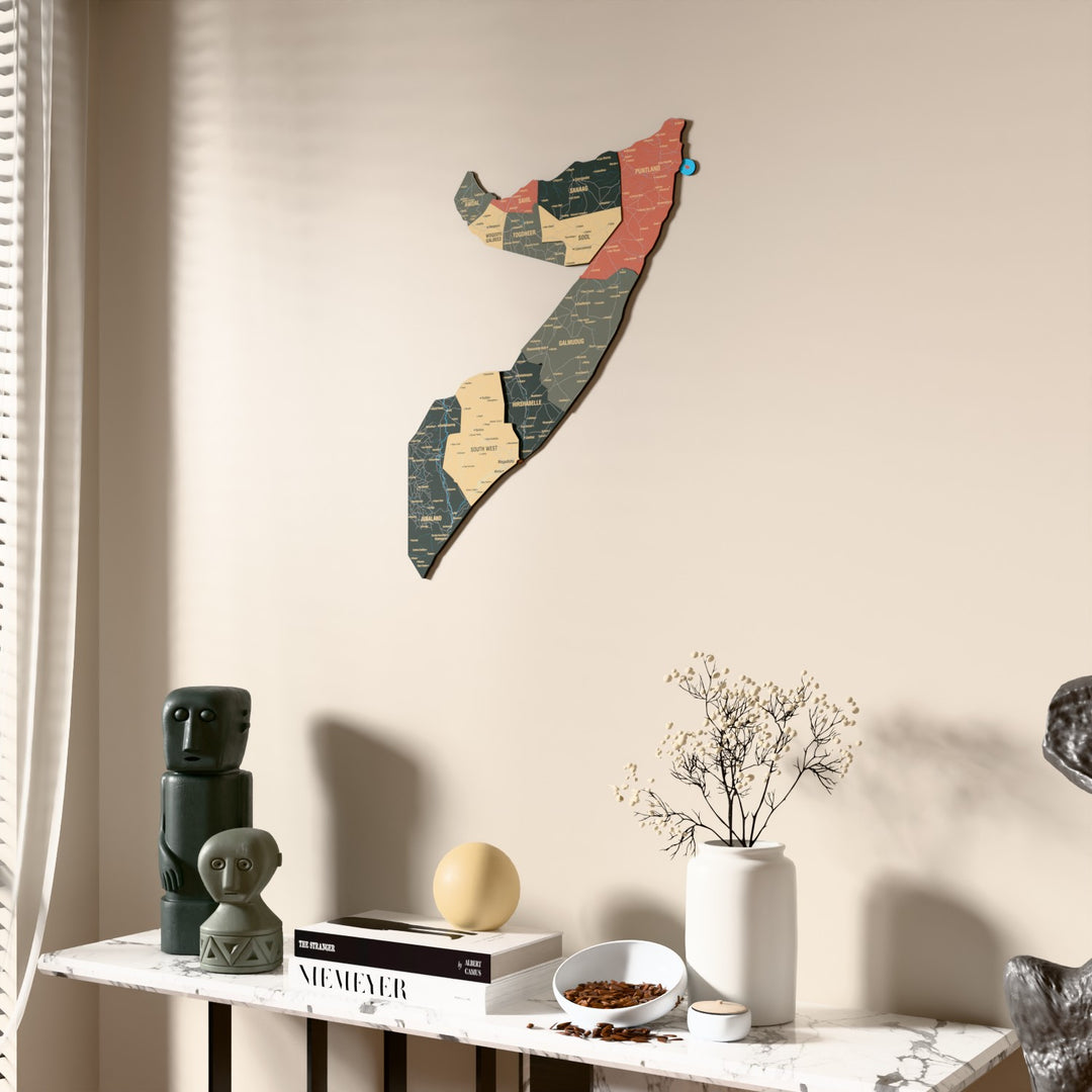 Sage Somalia wooden wall map beside a sheer curtain, angled view
