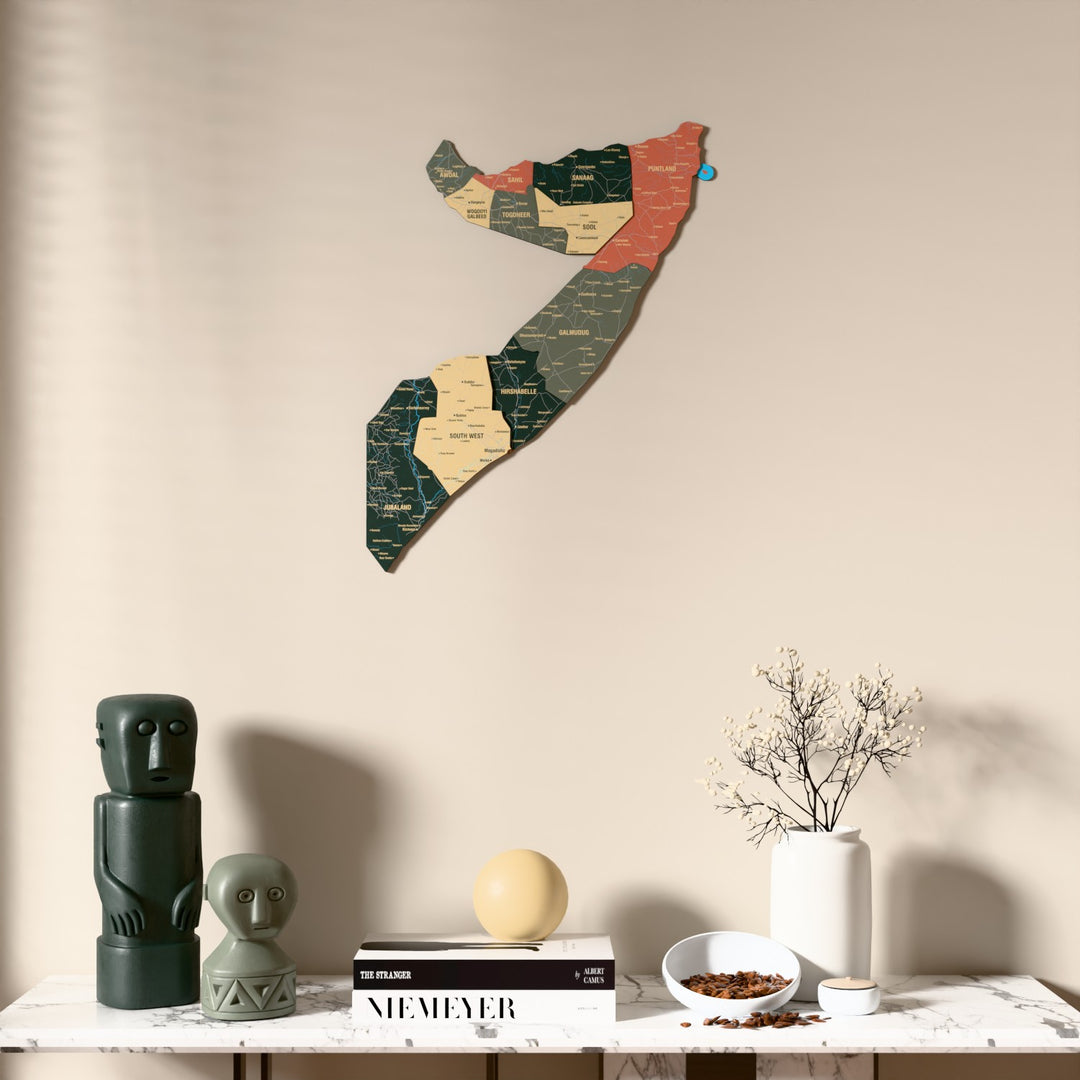 Sage Somalia wooden wall map above a marble console, front view