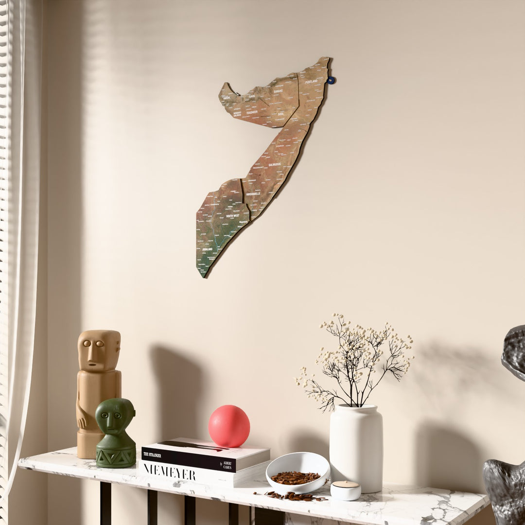 Satellite Somalia wooden wall map beside a sheer curtain, angled view