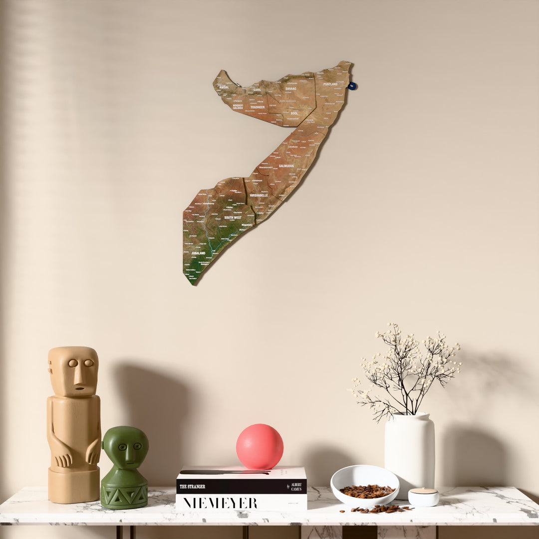 Satellite Somalia wooden wall map above a marble console, front view