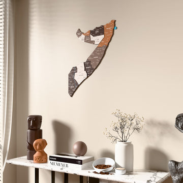 Soil Somalia wooden wall map beside a sheer curtain, angled view