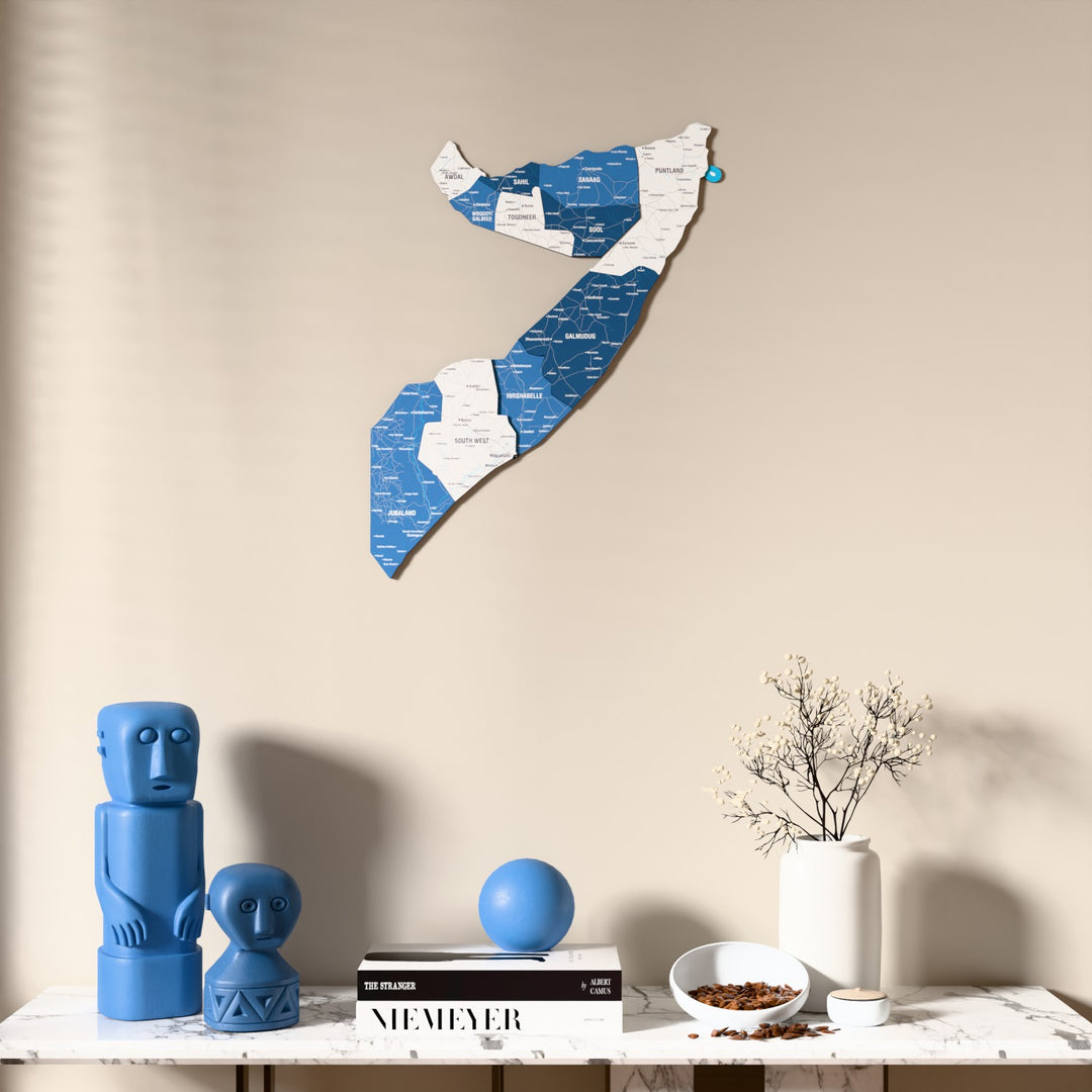 Flag colored Somalia wooden wall map above a marble console, front view