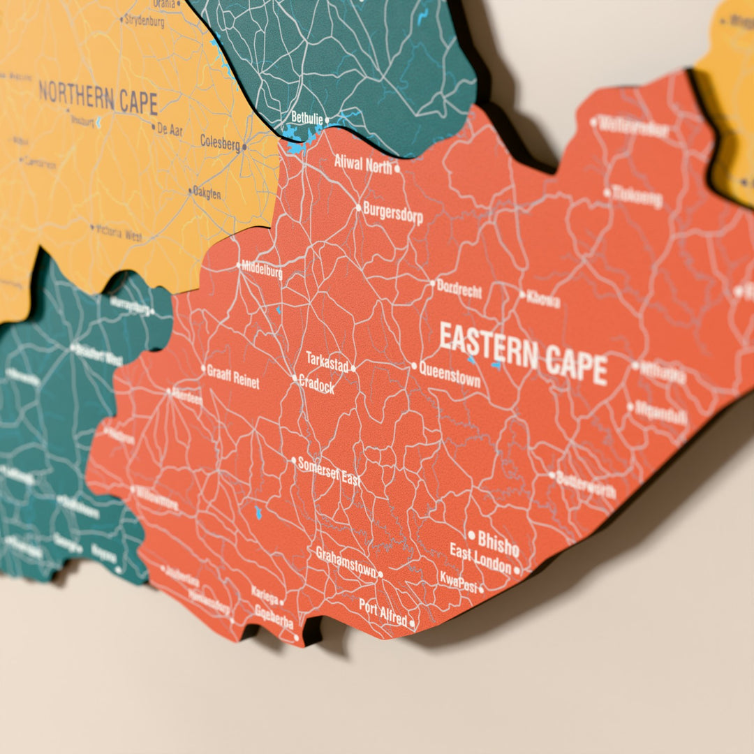 Close-up of the Flag colored South Africa wooden wall map with layered regions and printed names