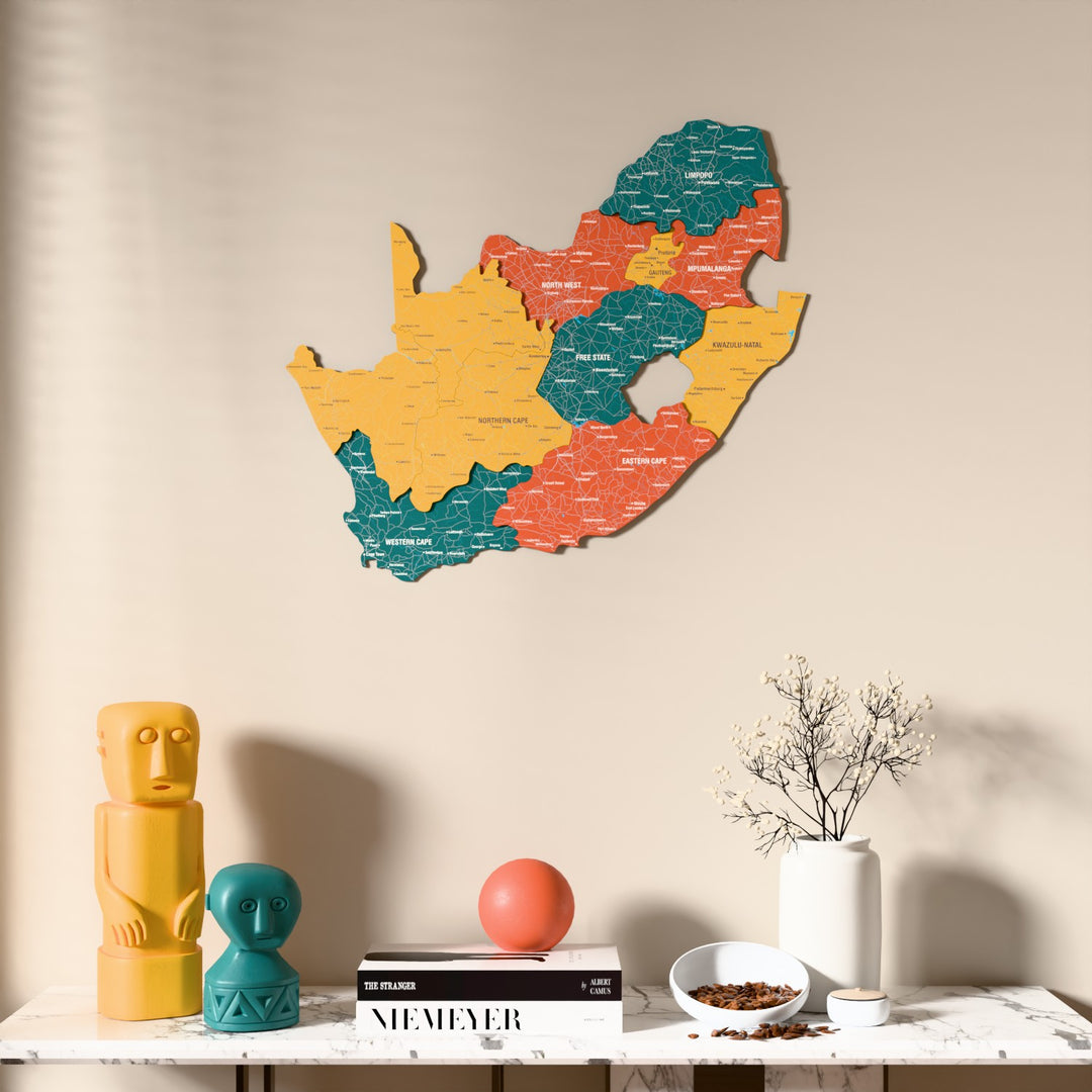 Flag colored South Africa wooden wall map above a marble console, front view