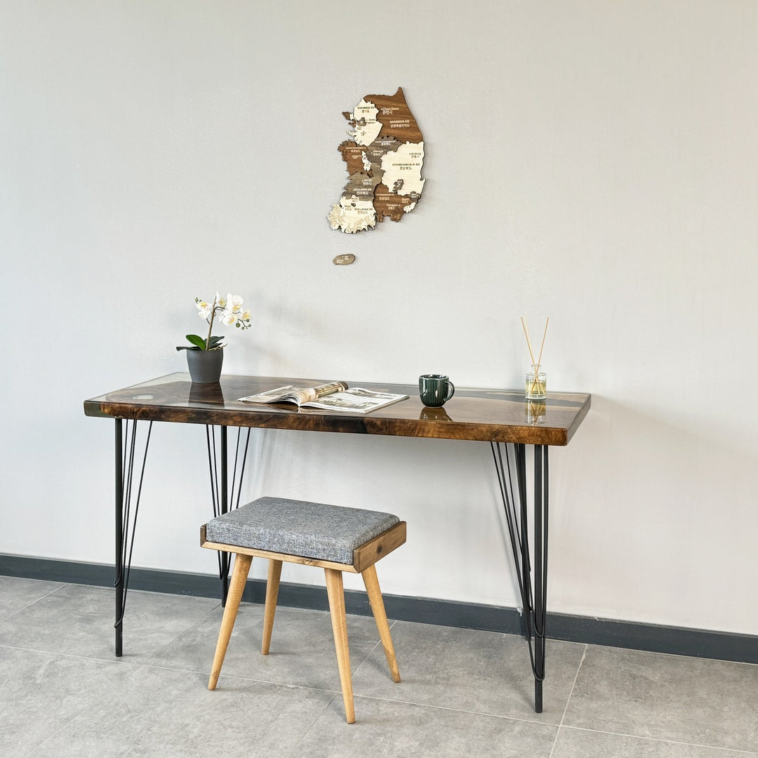 Small South Korea wooden wall map above a desk with a stool