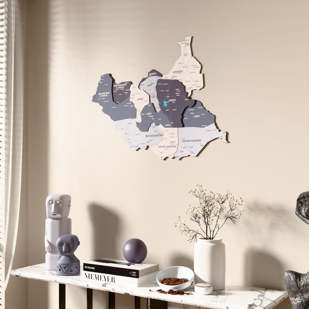 Nimbus South Sudan wooden wall map beside a sheer curtain, angled view