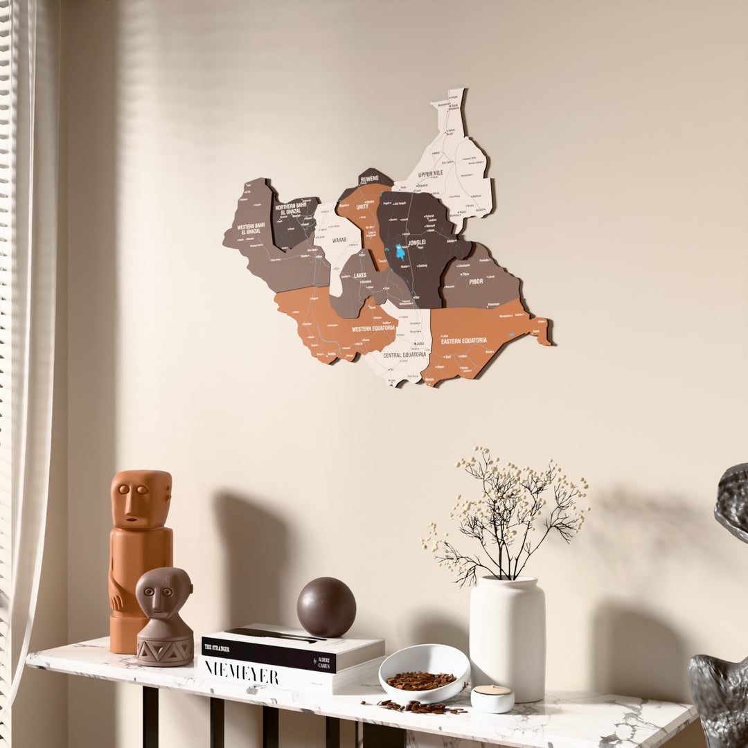 Soil South Sudan wooden wall map beside a sheer curtain, angled view