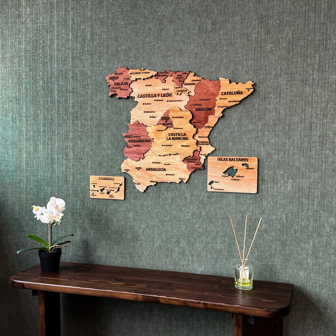 Spain plywood wall map above a dark console with a reed diffuser, slightly angled view