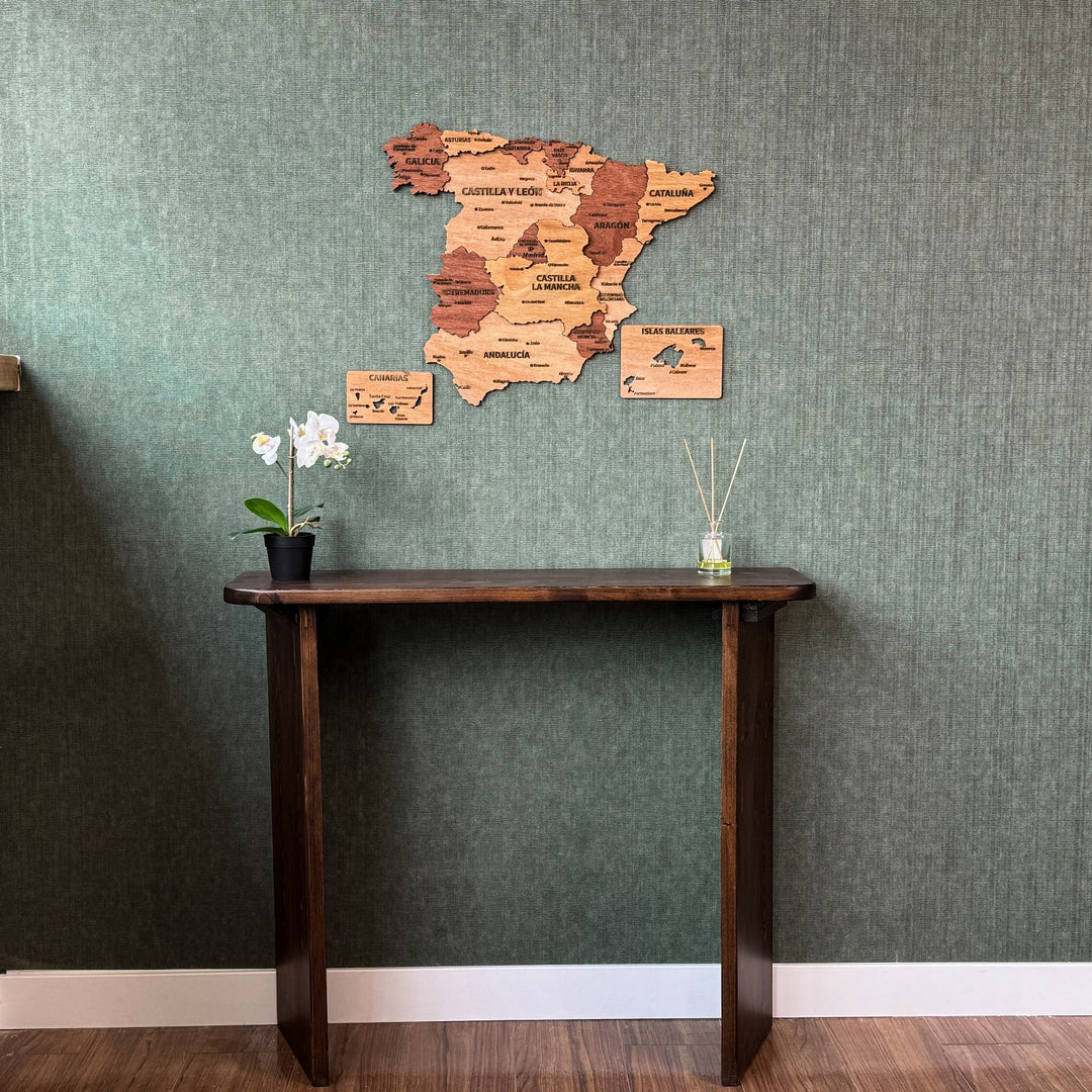 Spain wood wall map centered above a console with an orchid, full-length view