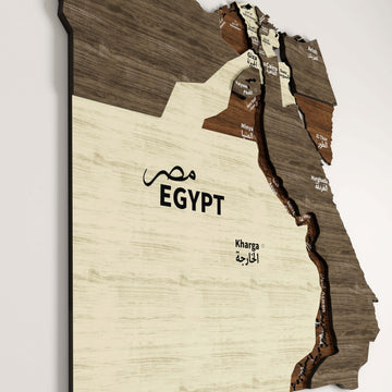 Close-up of the Egypt wooden wall map with EGYPT lettering in English and Arabic and the Kharga label on cream wood