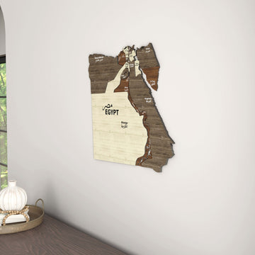 Egypt wooden wall map in a corner near a window, with a table and a white vase at the left