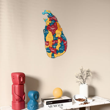 Flag colored Sri Lanka wooden wall map on a beige wall above a console with figurines