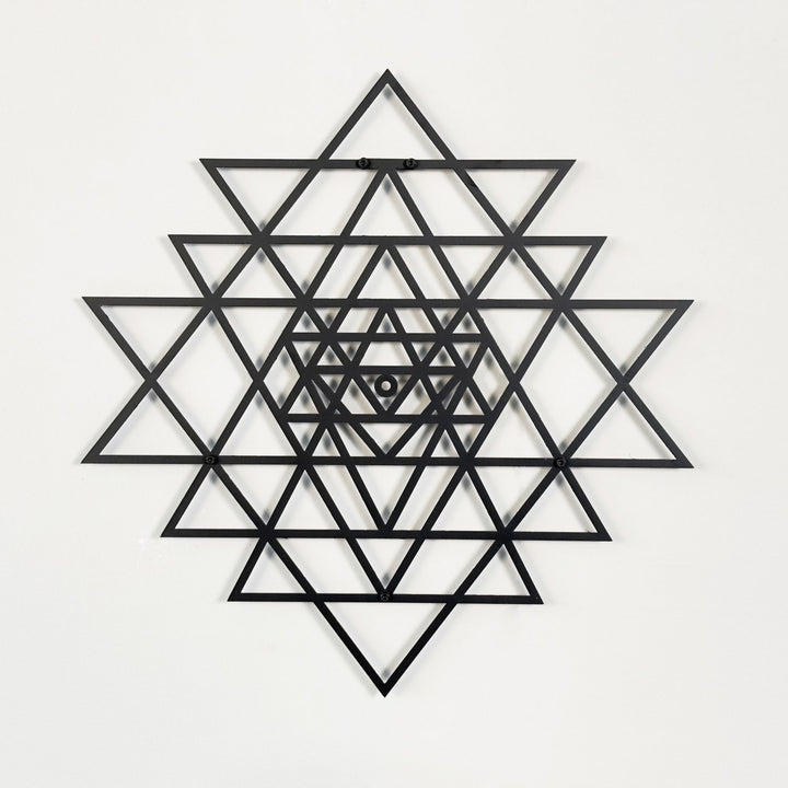 Black geometric sri yantra design on a white background