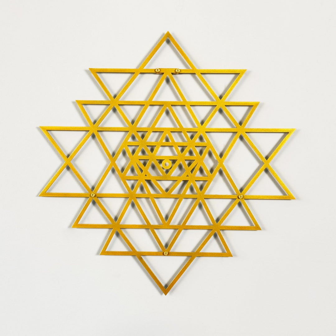 Gold geometric star design on a light gray background
