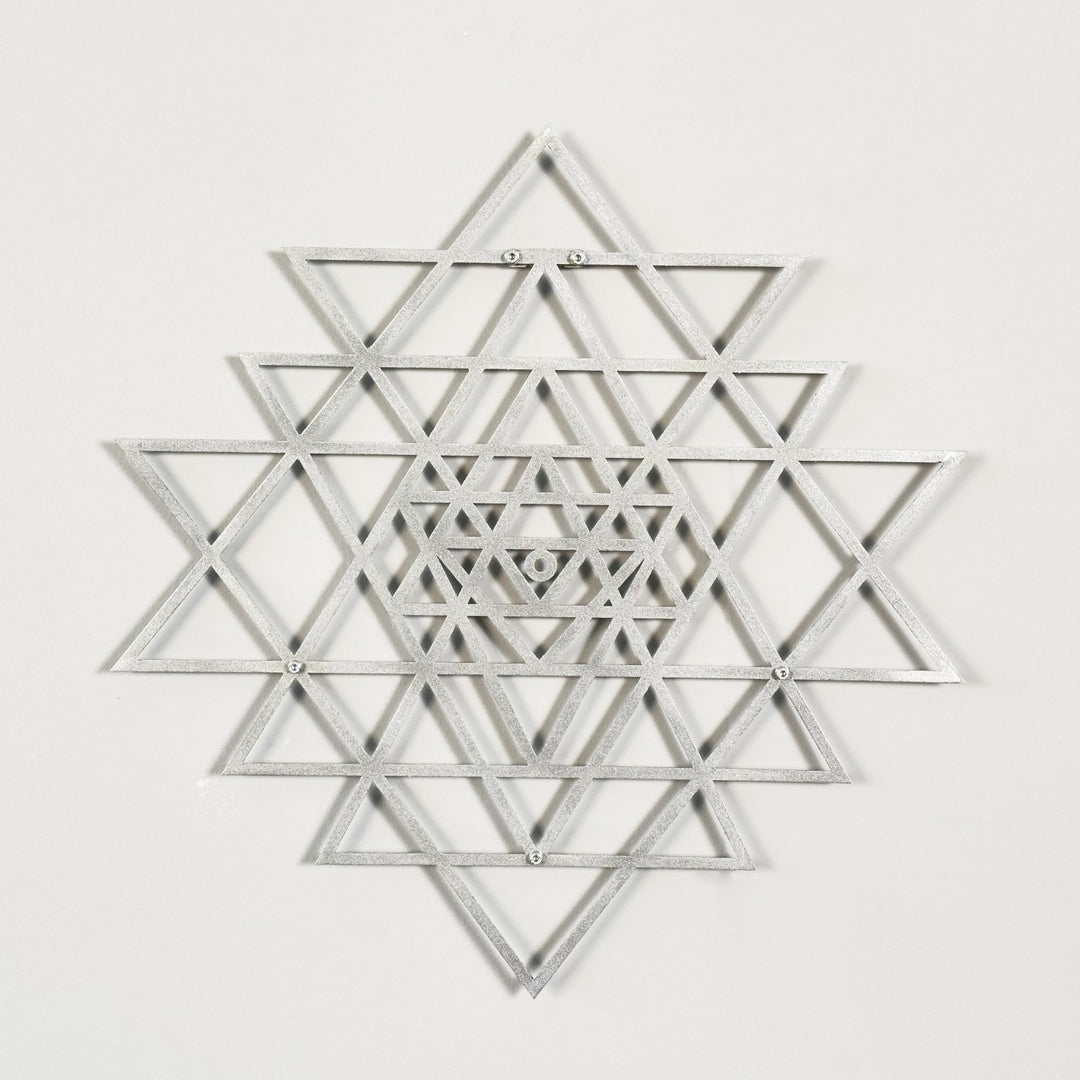 Silver geometric star design on a white background