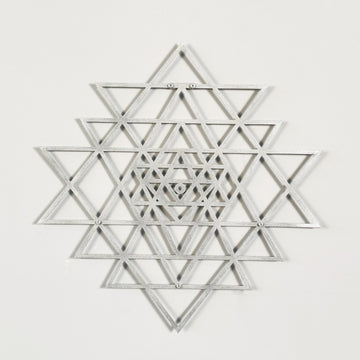 Silver geometric star design on a white background