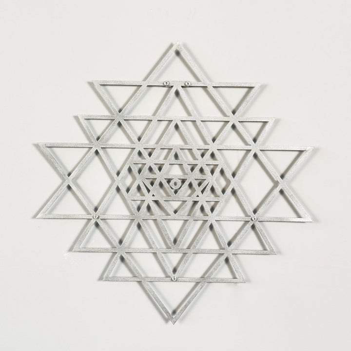 Silver geometric star design on a white background