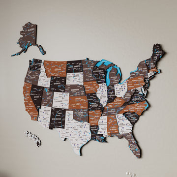 Large soil colored United States wooden wall map on a beige wall, showing Alaska, Hawaii and layered state panels