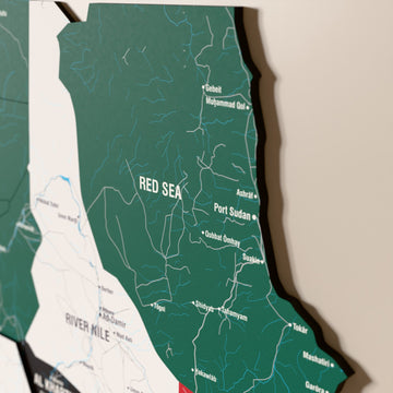 Close-up of the Flag colored Sudan wooden wall map with layered regions and printed names