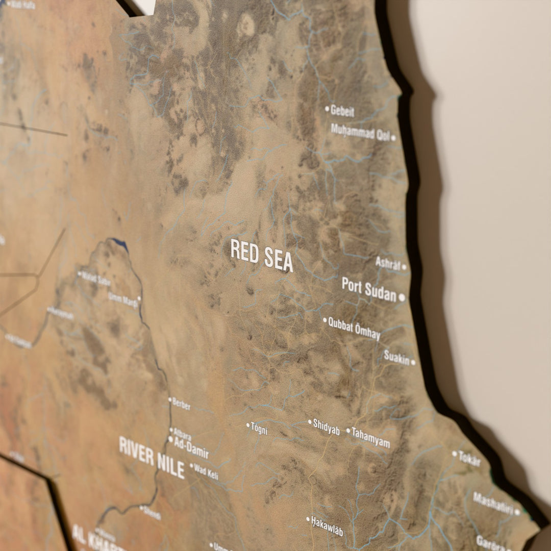 Close-up of the Satellite Sudan wooden wall map with layered regions and printed names